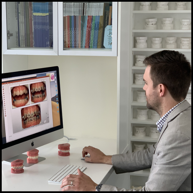 OSP Virtual consultation with Dr Simon Toms with models of braces and on an iMac with doxy.me software